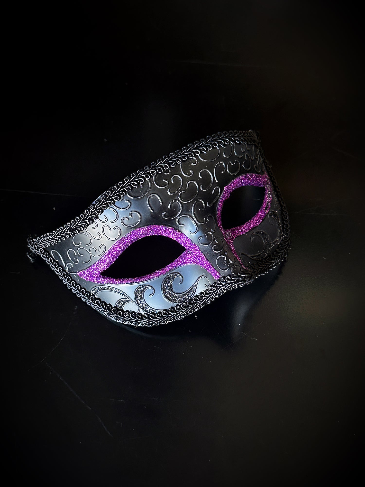 Mens Venetian masquerade mask in black with purple glitter eyes. 