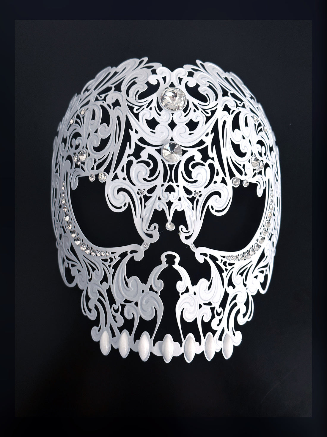 White metal skull masquerade mask for sale with rhinestone embellishment.