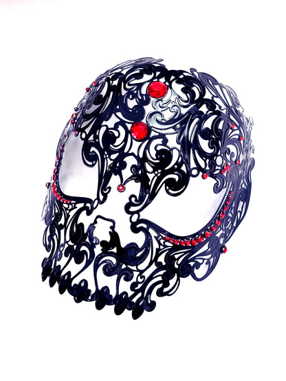 Metal skull masquerade mask in black with red stones.