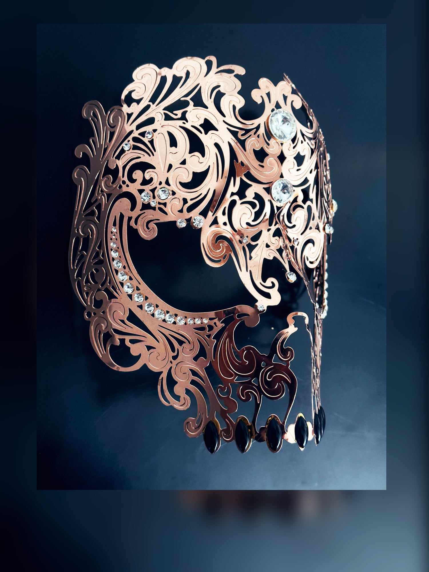 Mens metal skull masquerade mask in rose gold.