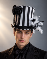 Midnight Cabaret Top Hat with black and white vertical stripes, oversized black satin rose, cascading black beads, and dramatic feather embellishments.