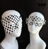 Monochrome Masquerade black and white couples mask set with men’s checker-pattern half mask and women’s ornate filigree crystal mask.