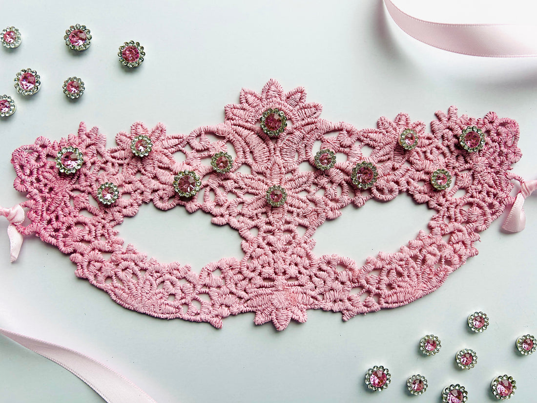 Pink lace masquerade mask with blush crystal rhinestones for moon ball and gala evening events.