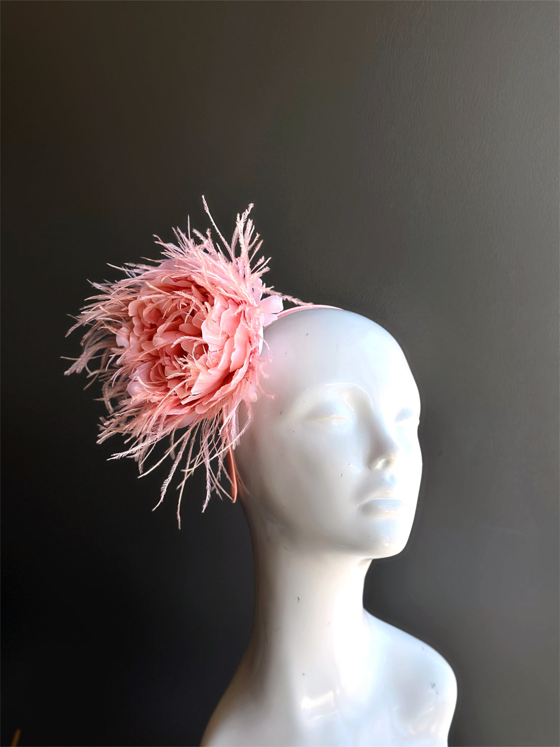 Pink feather bouquet fascinator hat with floral bloom and feather accents for Derby, weddings, and tea parties.