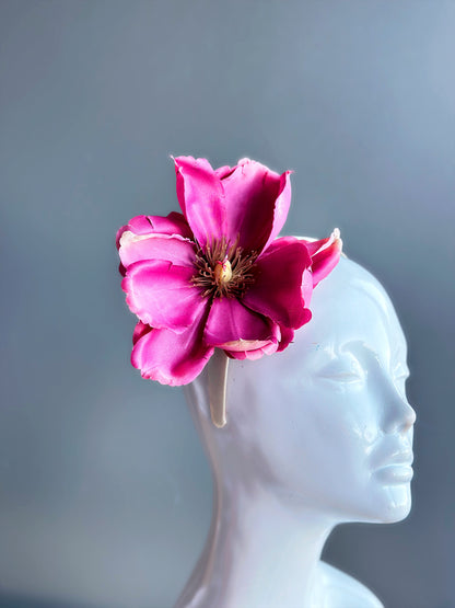 Pink oversized flower fascinator hat, elegant Derby and wedding headpiece for cocktail parties and masquerade events.