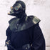 Man in gothic black leather plague doctor mask and robe with walking stick
