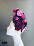 Plum and magenta floral bouquet fascinator hat with roses for weddings and tea parties.