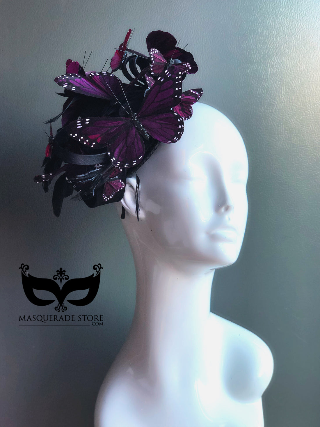Purple butterfly fascinator hat with layered butterflies and feathers for gothic masquerade or Halloween look.