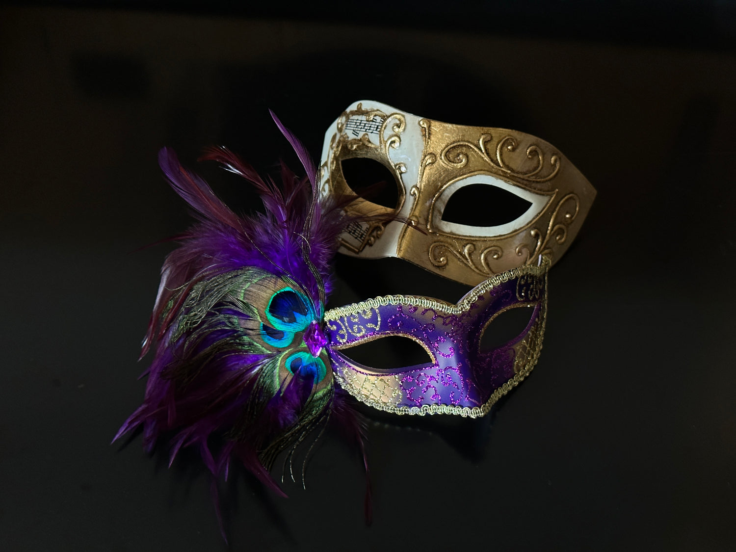 Purple and gold couples masquerade masks with peacock feathers and baroque scrollwork design, perfect for prom or themed parties.