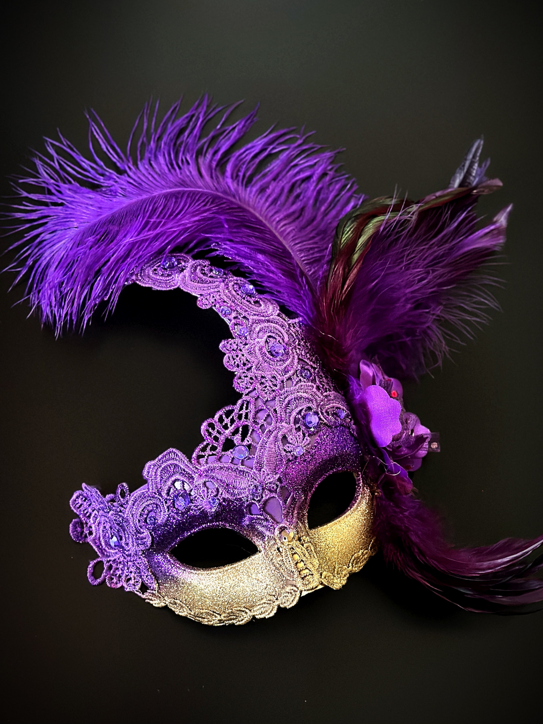 Elegant purple masquerade mask with tall feathers and gold accents