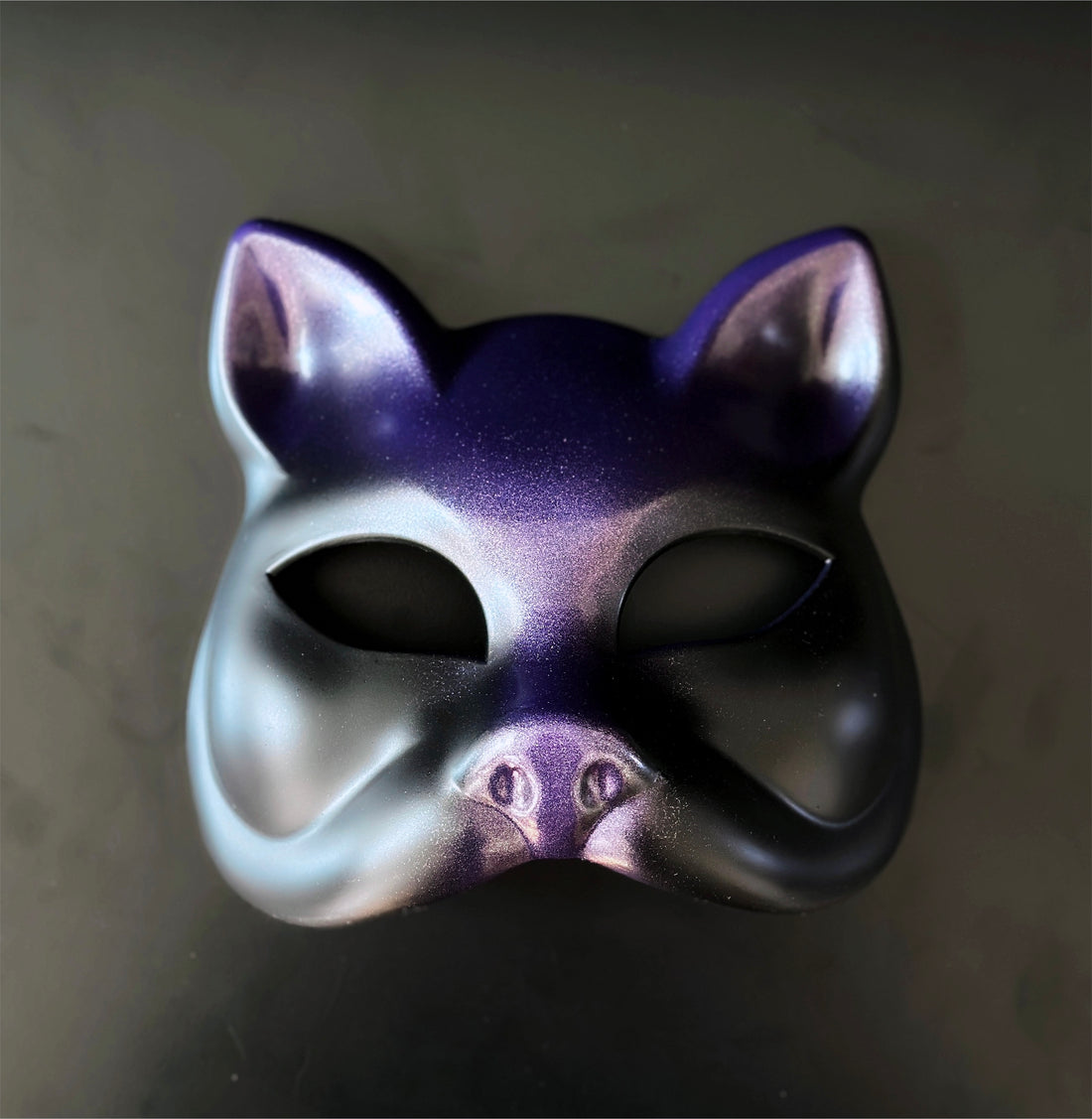 Purple and black metallic cat masquerade mask with smooth finish for costume events.