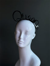 Black minimalist ribbon fascinator headband with sculpted loop design.