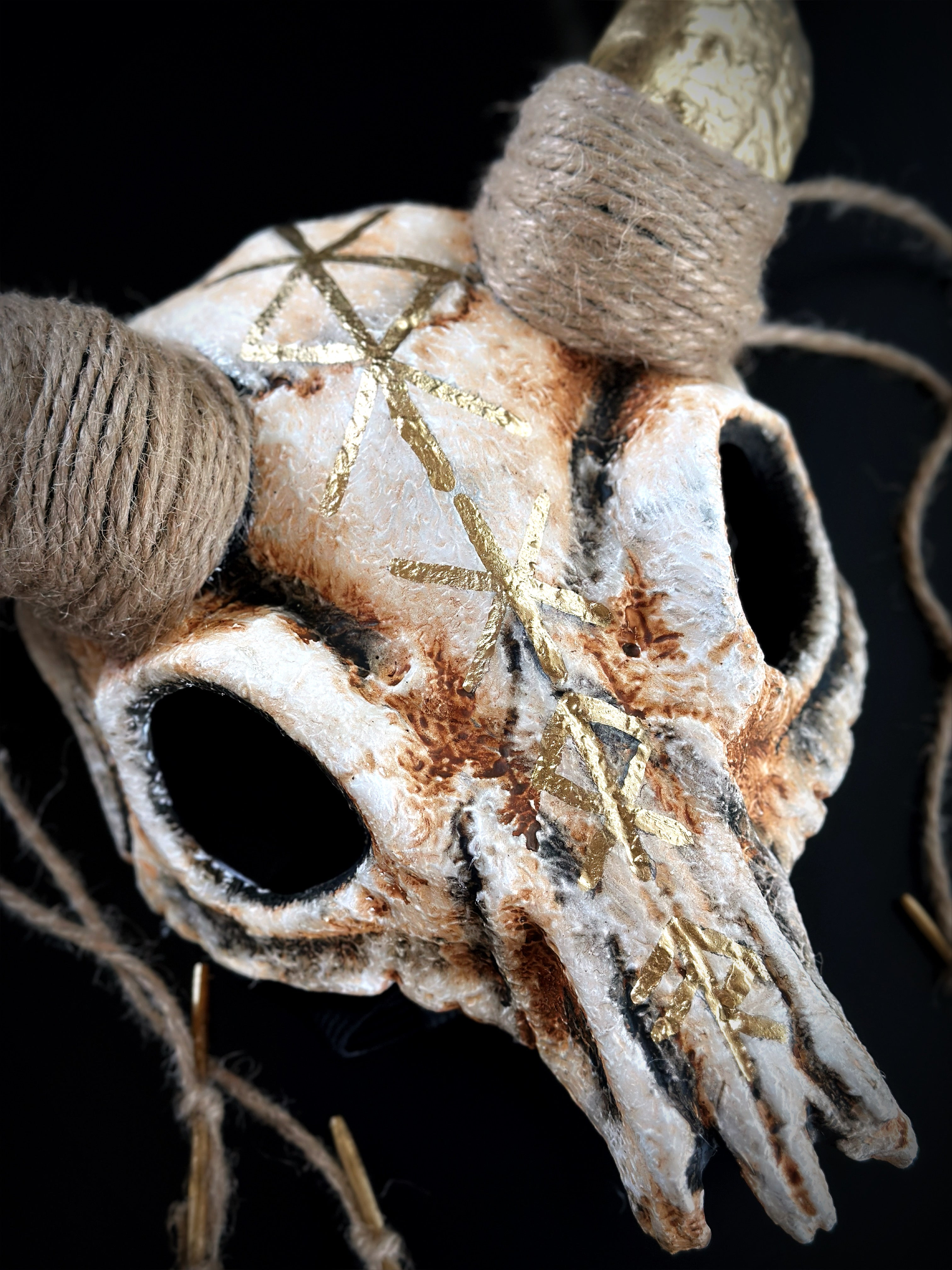 Halloween costume mask with ram skull design, golden runes, and twine horns