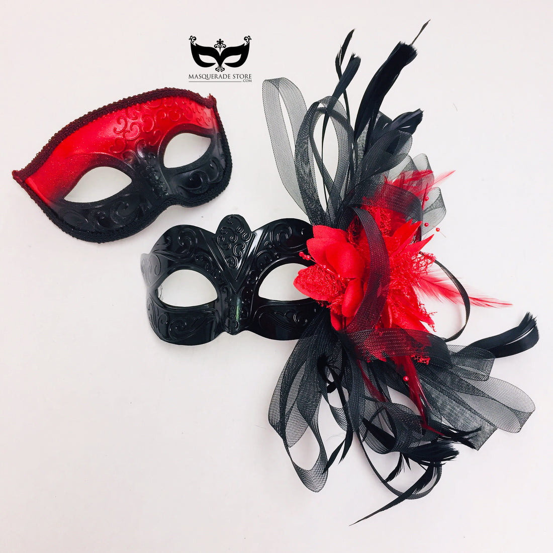 Red and black couples masquerade mask set with glitter trim, feathers, and floral accents for costume parties and masquerade balls.