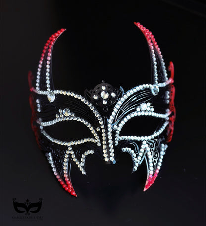Red and black horned masquerade mask with rhinestone accents, curved horn points, ribbon ties, and gothic Venetian-inspired styling for formal events.