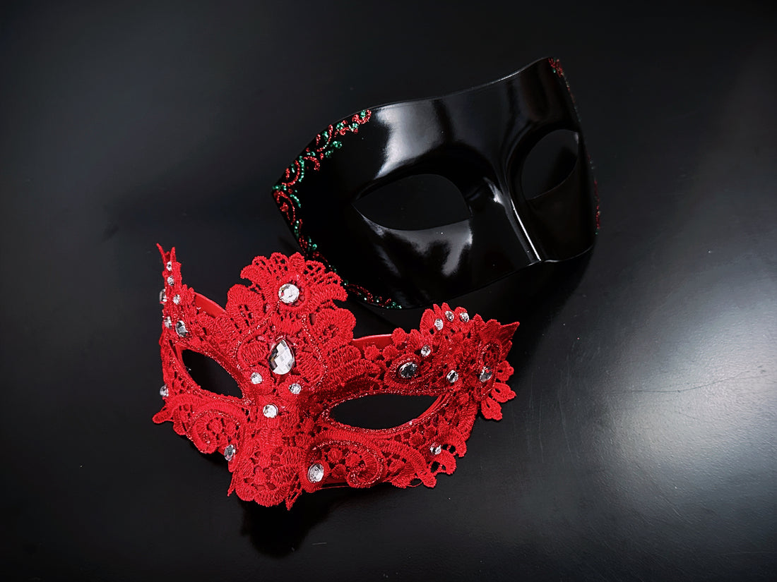 Elegant red rhinestone lace mask paired with a sleek black masquerade mask, ideal for romantic themed events.