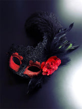 Red and black women’s masquerade mask with lace, glitter, feathers, and a red flower accent, designed for Venetian masquerade balls and Mardi Gras events.
