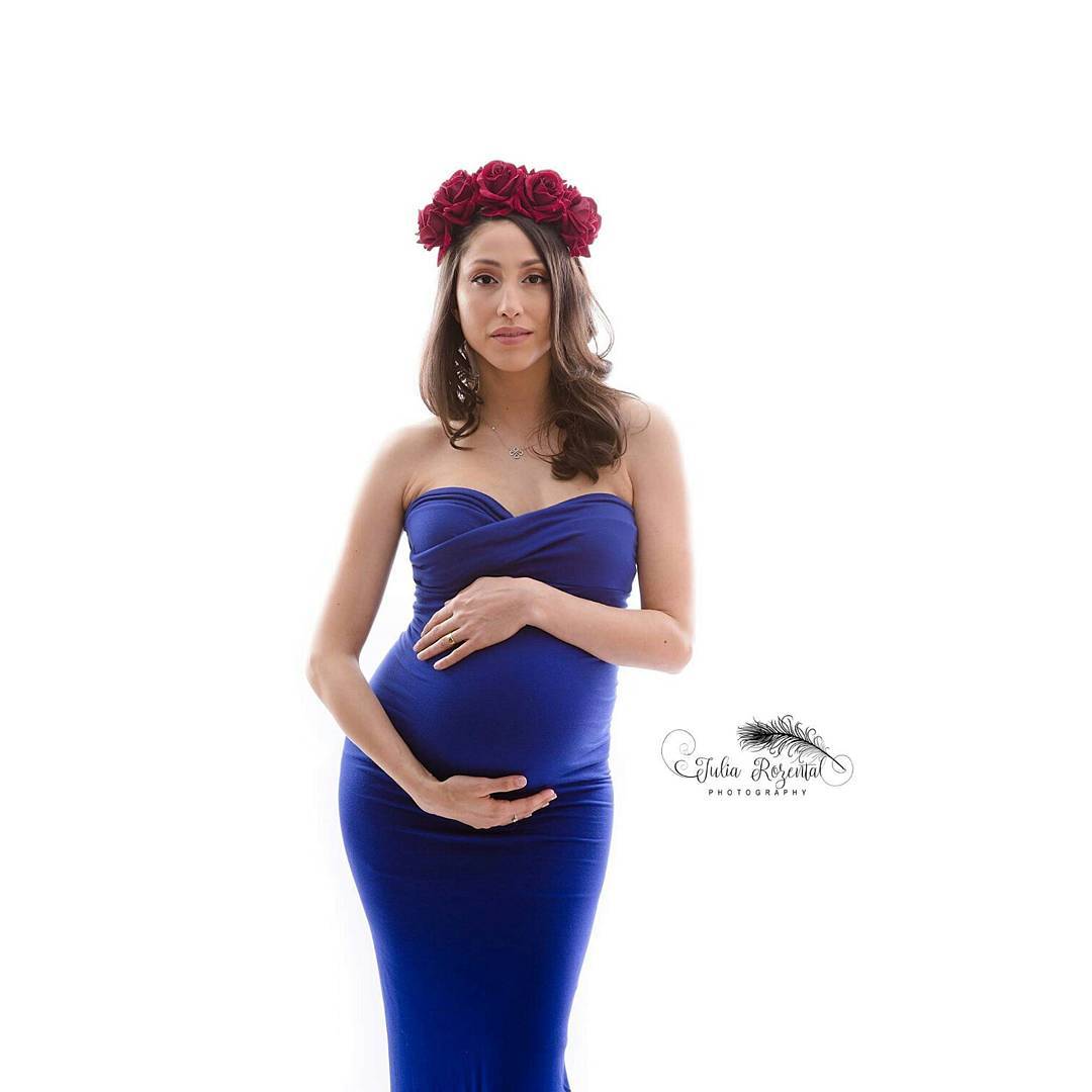 Elegant red rose headband on pregnant woman in royal blue gown
