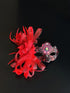 Red lace masquerade mask with feather flower and crystal details for gala and formal masquerade events.