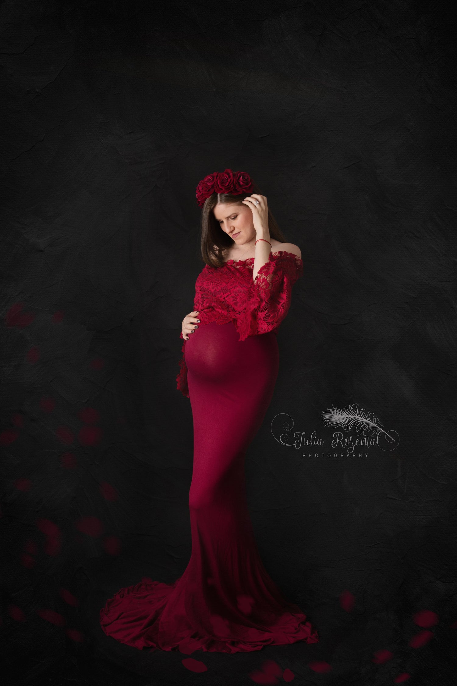 Deep red floral maternity crown styled for a photoshoot with matching dress