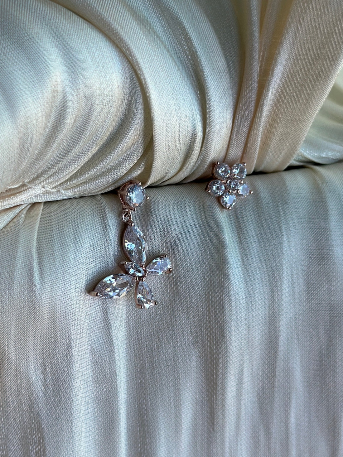 Floral-inspired non-tarnish rose gold earrings with sparkling stones.