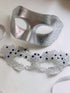 Elegant silver couples masquerade masks featuring an engraved men’s mask and a delicate silver lace women’s mask adorned with blue rhinestones, perfect for weddings, balls, and themed events.