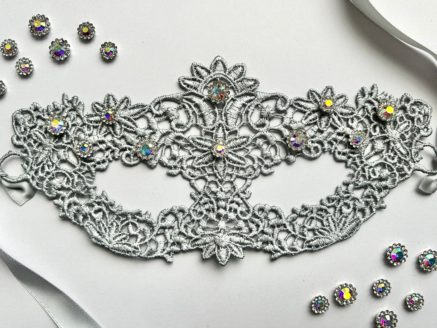 Silver floral lace masquerade mask with aurora rhinestones for moon ball and Venetian gala events.