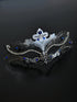 Silver masquerade mask with ornate filigree, rhinestones, and sapphire blue gems, perfect for women at Venetian masquerade balls, Mardi Gras, and parties.