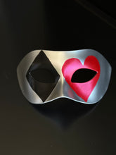Silver casino masquerade mask with black diamond and red heart playing card motifs on Venetian eye-mask silhouette