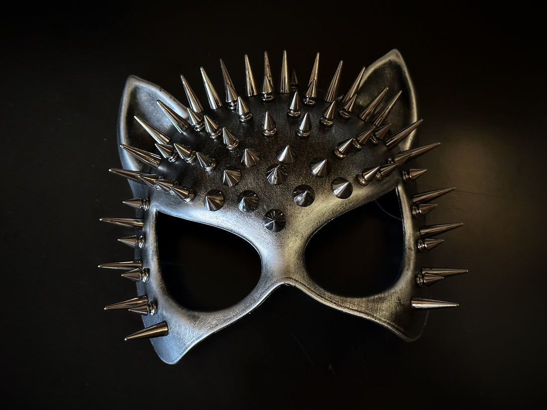 Metallic silver cat ear masquerade mask with bold black ombré and dramatic silver spikes, styled for edgy party or Halloween looks.