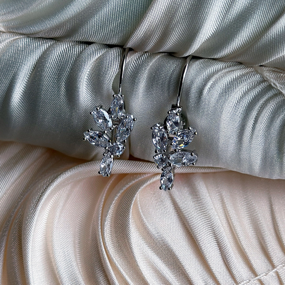Elegant silver-toned non-tarnish earrings with delicate floral crystal arrangement