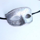 Elegant silver masquerade mask with glitter swirl design and sparkling trim for prom, weddings, and costume parties