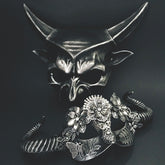 Gothic silver masquerade mask pair featuring sculpted horns, filigree flowers, and fantasy-inspired details.