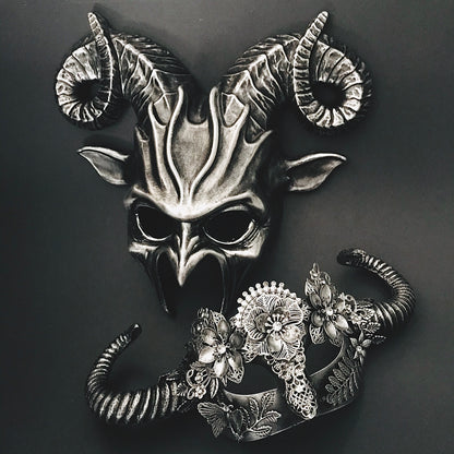 Horned silver masquerade mask duo featuring sculpted design and intricate floral lace accents.