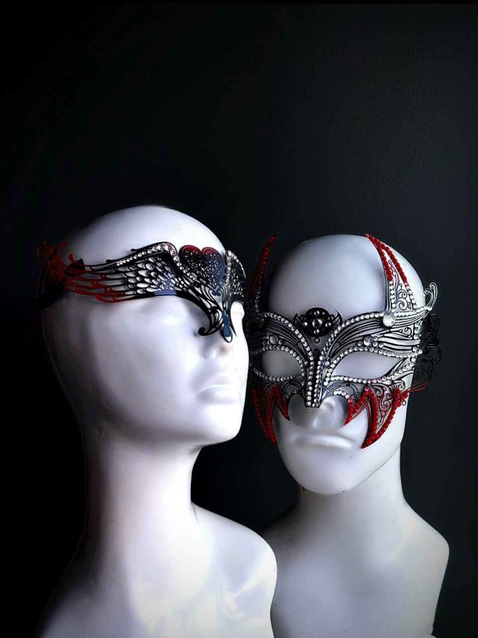 Elegant red and silver matching masquerade masks for couples featuring dramatic winged detail