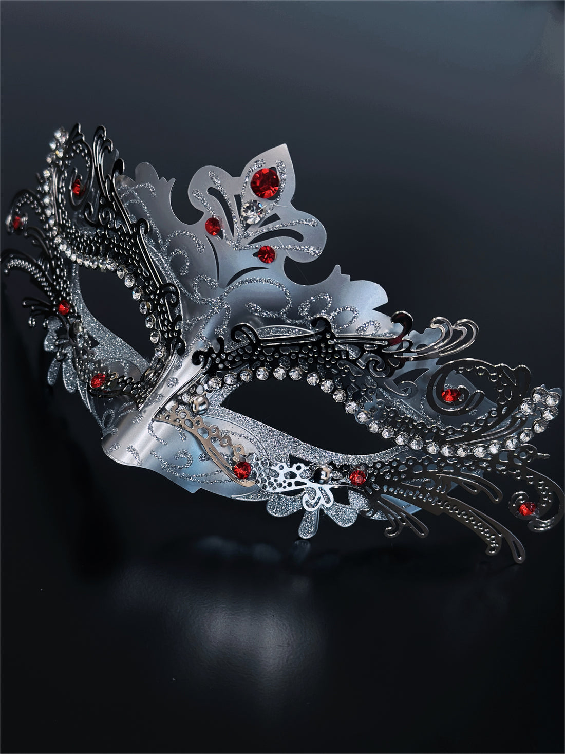 Silver masquerade mask with rhinestones and red gemstone accents, crafted in ornate filigree, perfect for women at Venetian masquerade balls and prom.