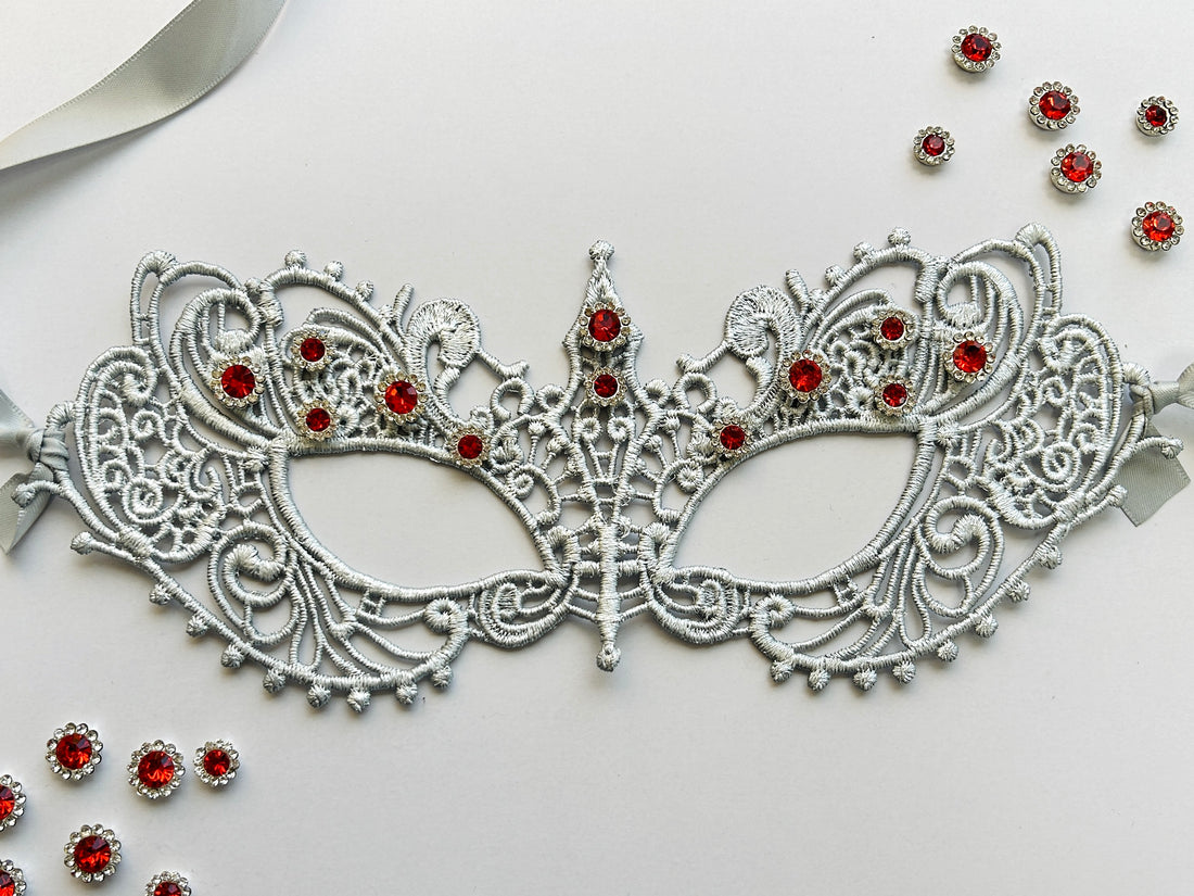 Silver lace masquerade mask with ruby red rhinestones for Venetian gala and formal ballroom events.