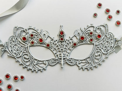 Silver lace masquerade mask with ruby red rhinestones for Venetian gala and formal ballroom events.