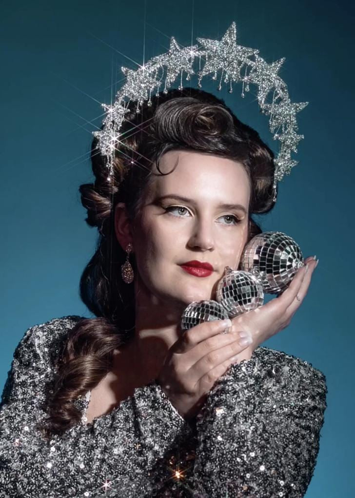 Sparkling silver starburst halo headpiece styled with sequin outfit and vintage waves