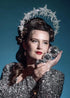 Sparkling silver starburst halo headpiece styled with sequin outfit and vintage waves