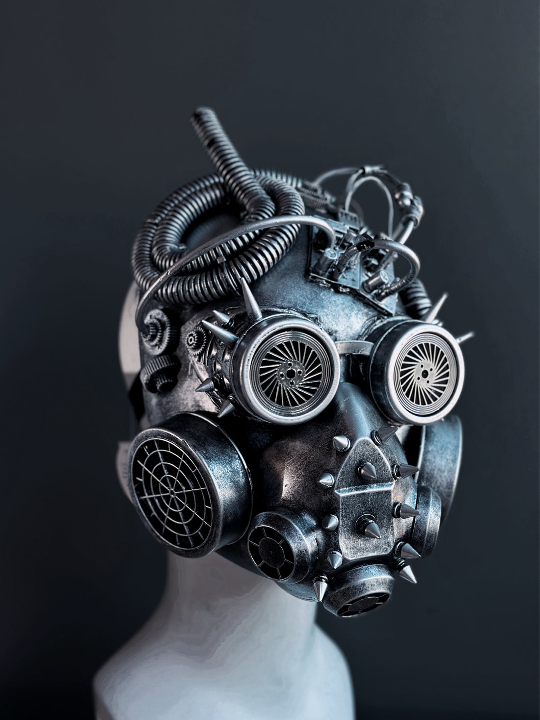 Metallic industrial-style steampunk helmet featuring spikes, vents, and sculpted tubing for dystopian costume wear