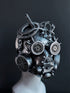 Metallic industrial-style steampunk helmet featuring spikes, vents, and sculpted tubing for dystopian costume wear

