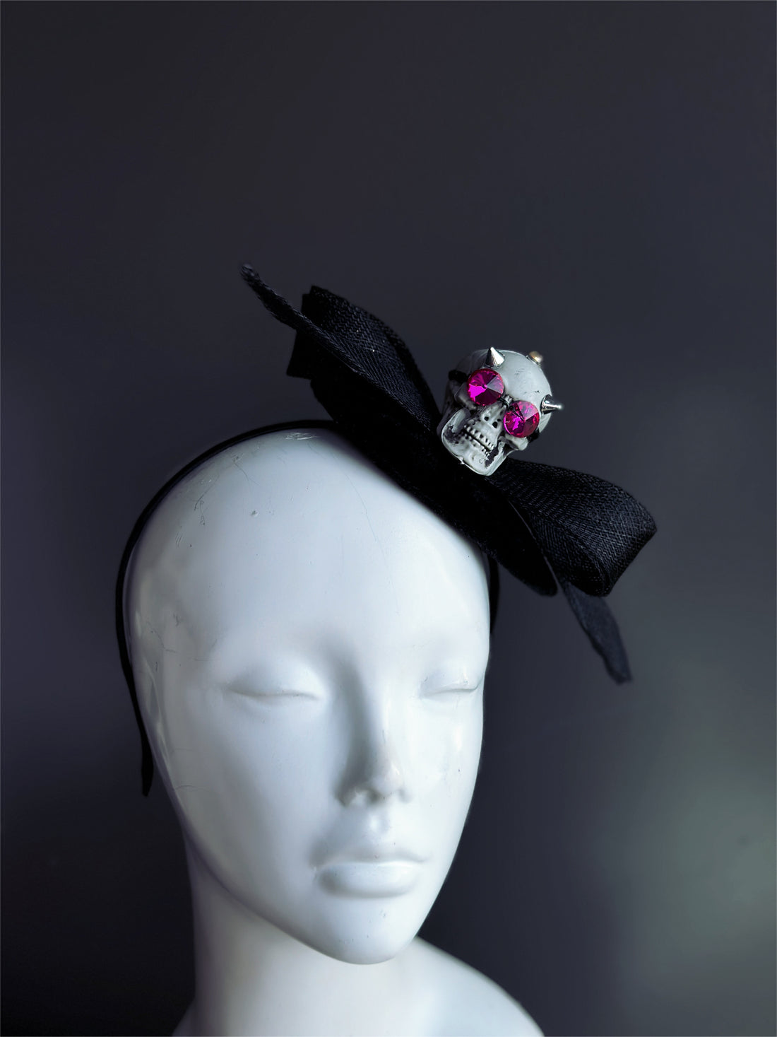 Halloween skull fascinator hat with black bow and rhinestone skull detail.