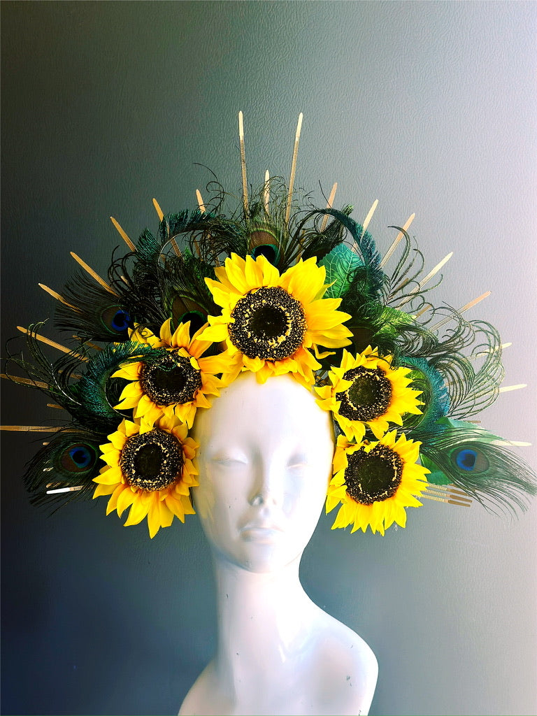 Bold sunflower headdress with vibrant peacock feathers and gold spikes—perfect for festivals, photo shoots, and dramatic entrances.
