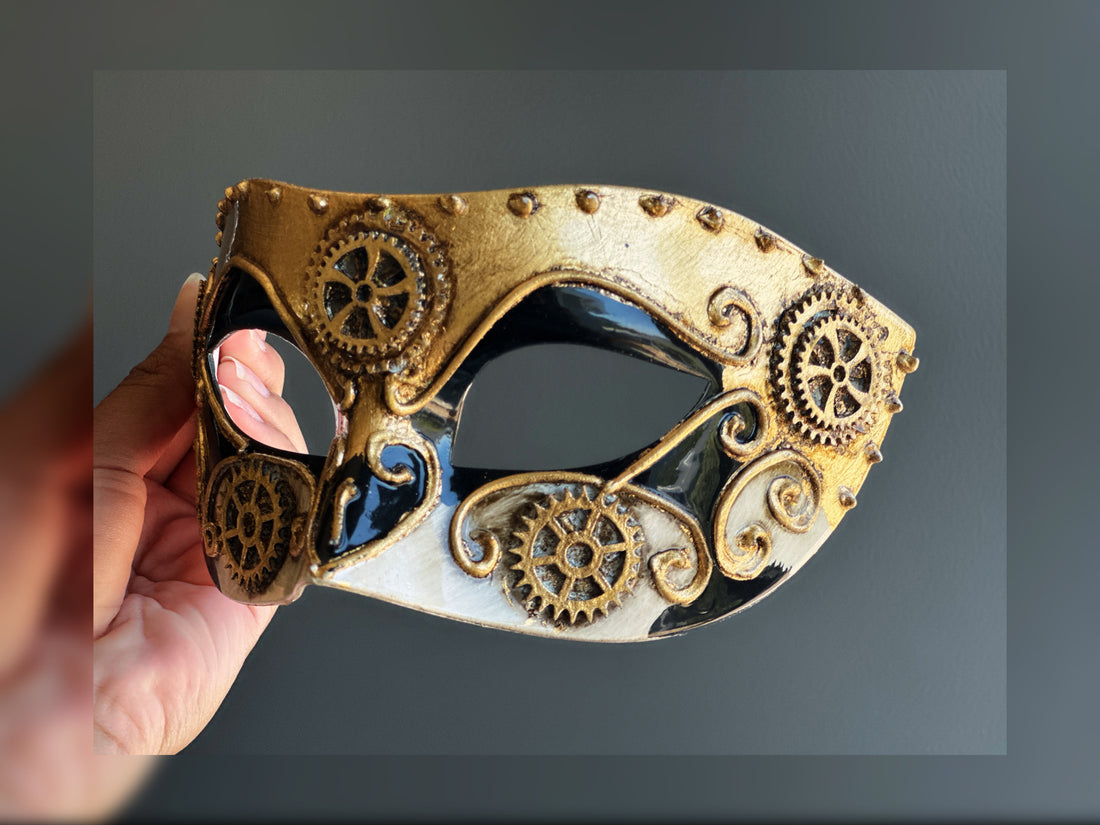 Steampunk masquerade mask in gold, black, and white with gear accents, perfect for Halloween, cosplay, or Victorian-themed masquerade balls.