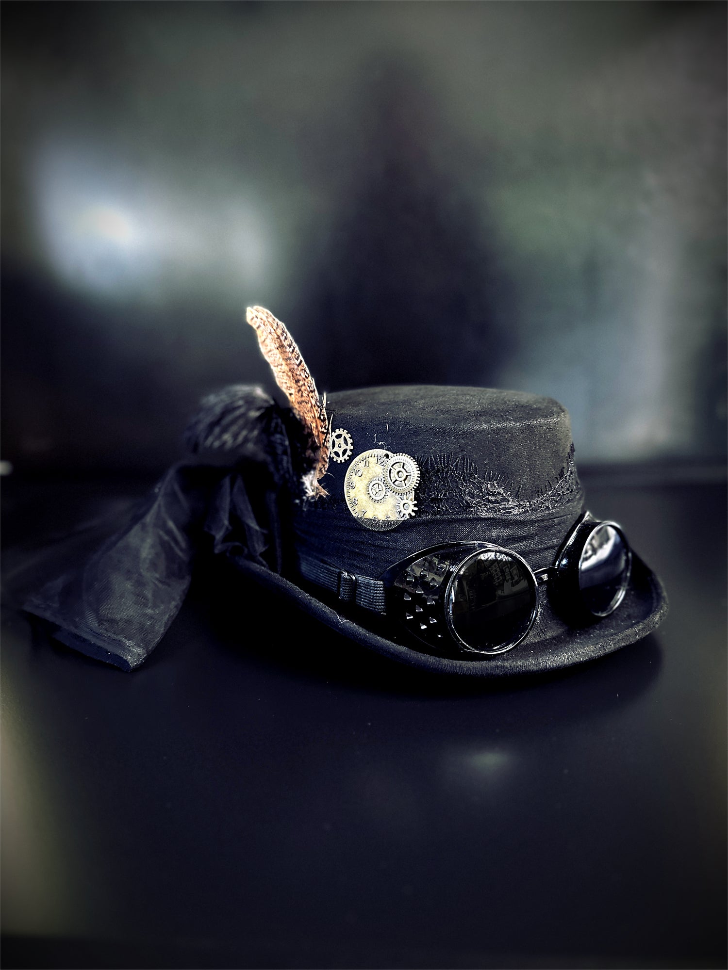 Black steampunk hat with a veil and goggles.