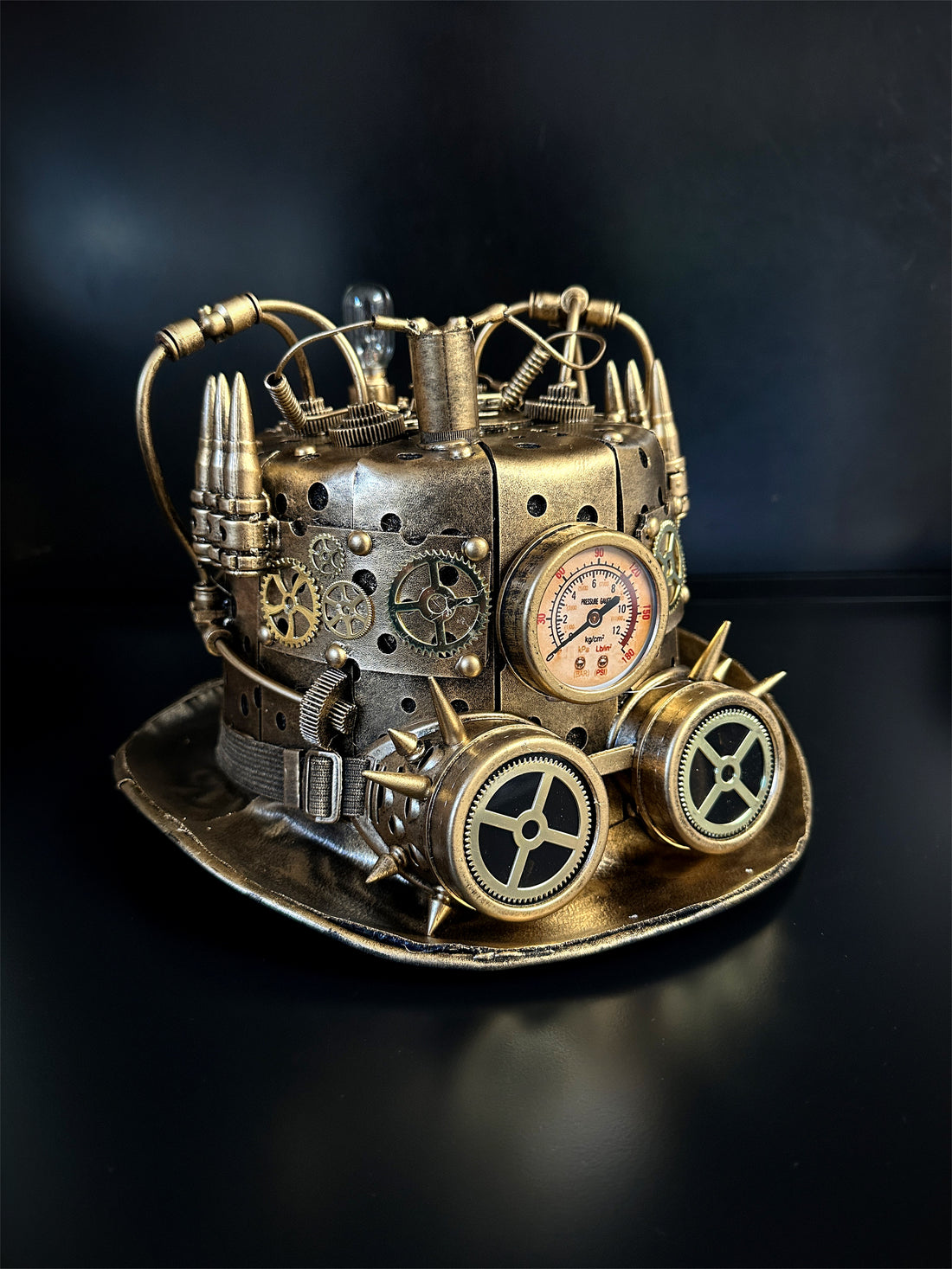 Gold steampunk hat with spike goggles.