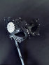 Swan black metal handheld mask with white brooch, it will be the perfect finishing touch to you ensemble!