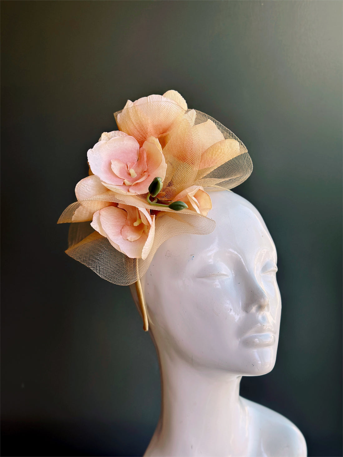 Peach and gold tea party fascinator hat with floral and tulle accents for weddings, Kentucky Derby, and spring events.