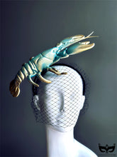 Turquoise and gold lobster fascinator hat with netted veil, perfect for Derby, masquerade balls, couture shows, and avant-garde fashion.